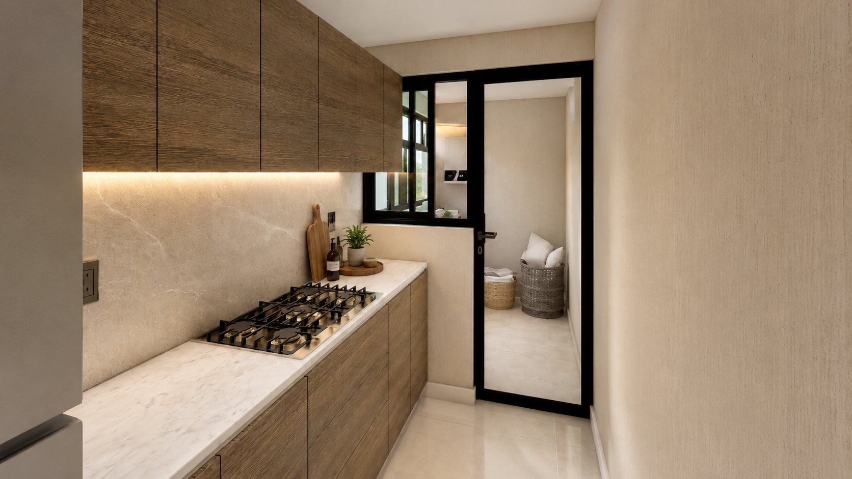 Cocina lineal con gabinetes en madera oscura, cubierta negra y recubrimiento tipo piedra iluminado.